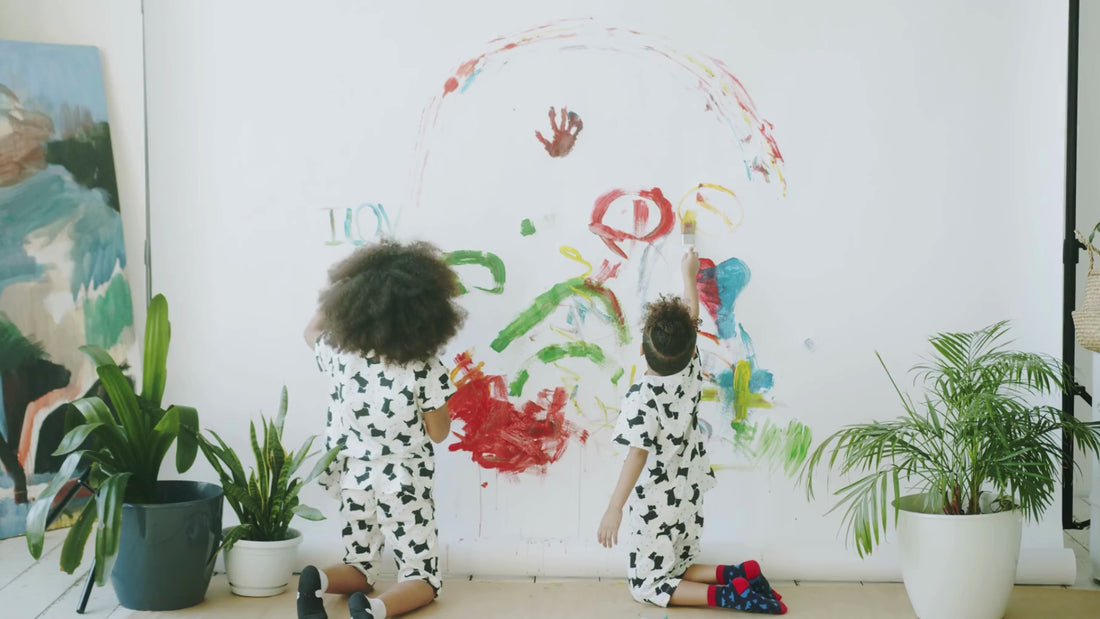 Children painting on wall